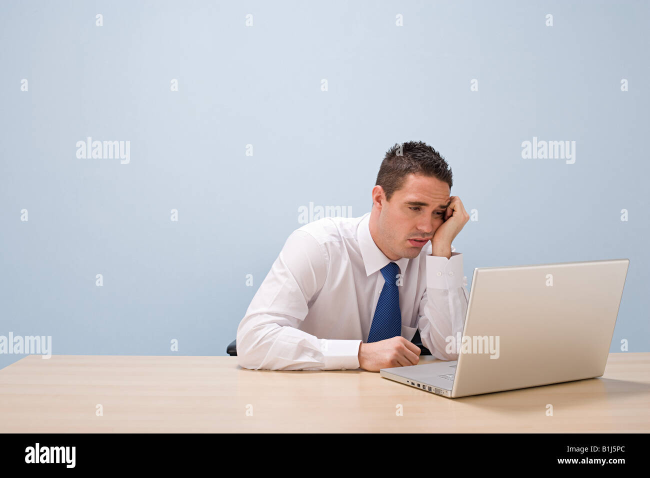 Fed up man with laptop Stock Photo - Alamy