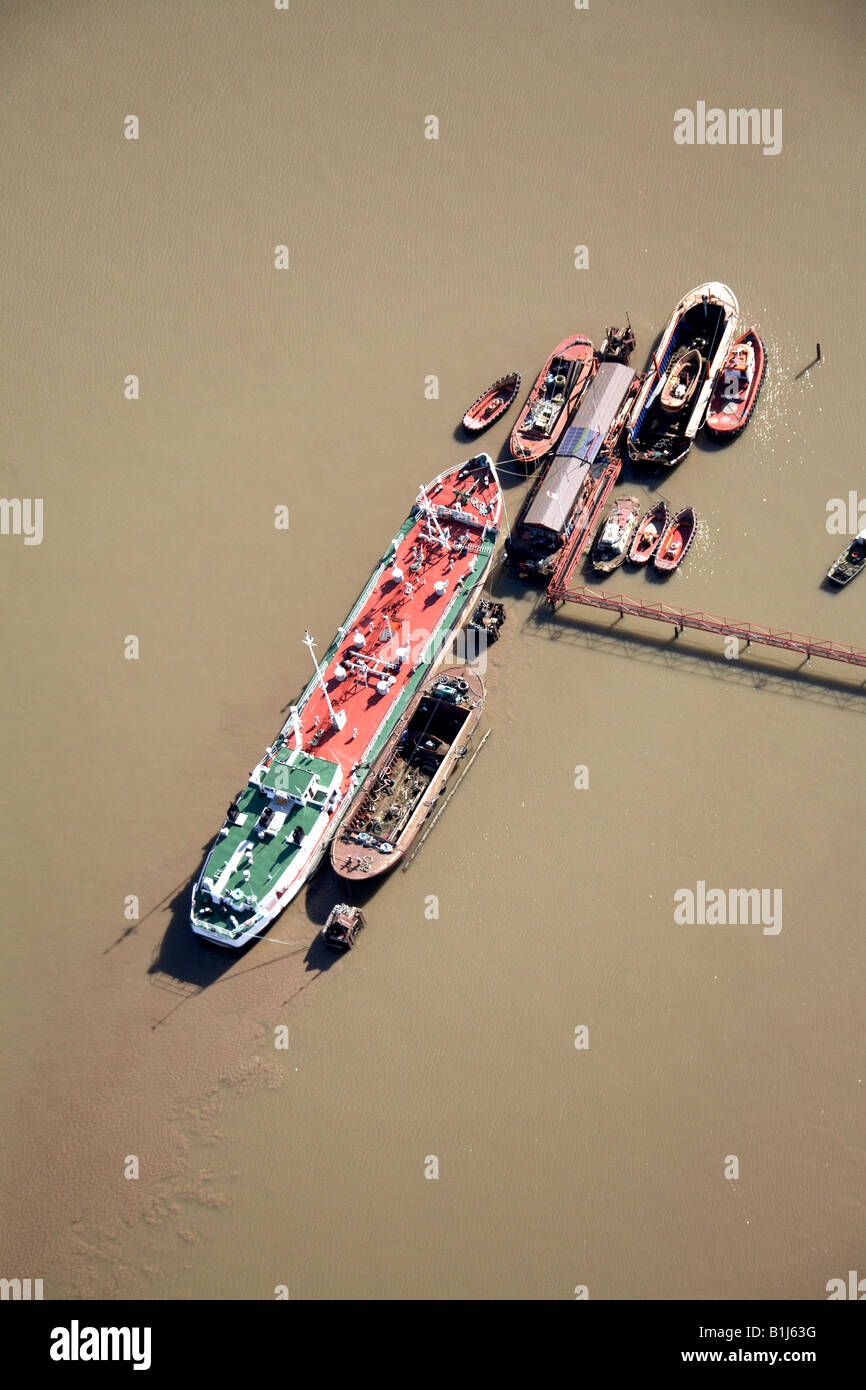 Aerial abstract view south east of Merchant Ships and Boats Erith Reach River Thames London DA8 England UK High level oblique Stock Photo