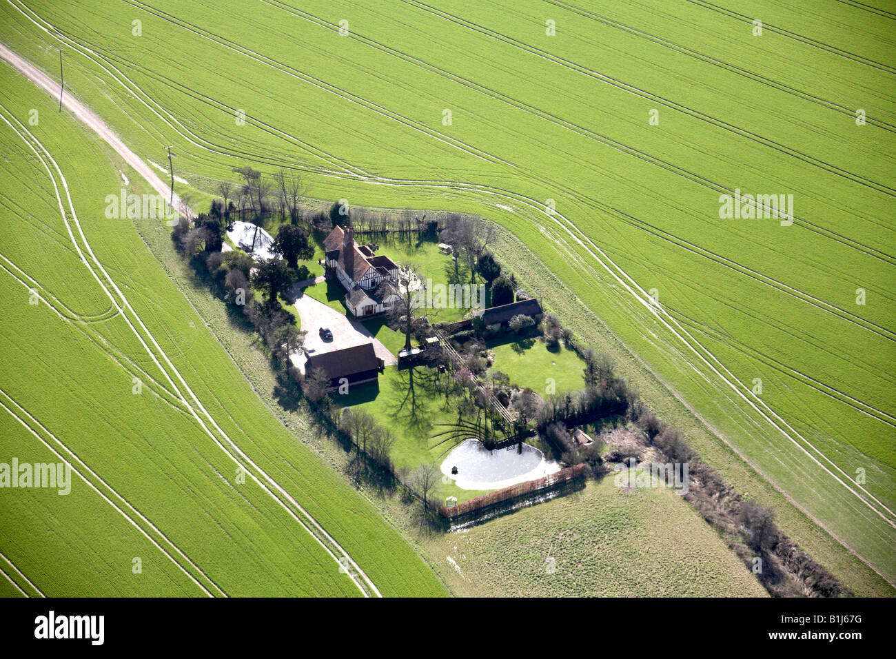 Aerial view of country houses and fields near Romford Essex London RM4 England UK High level