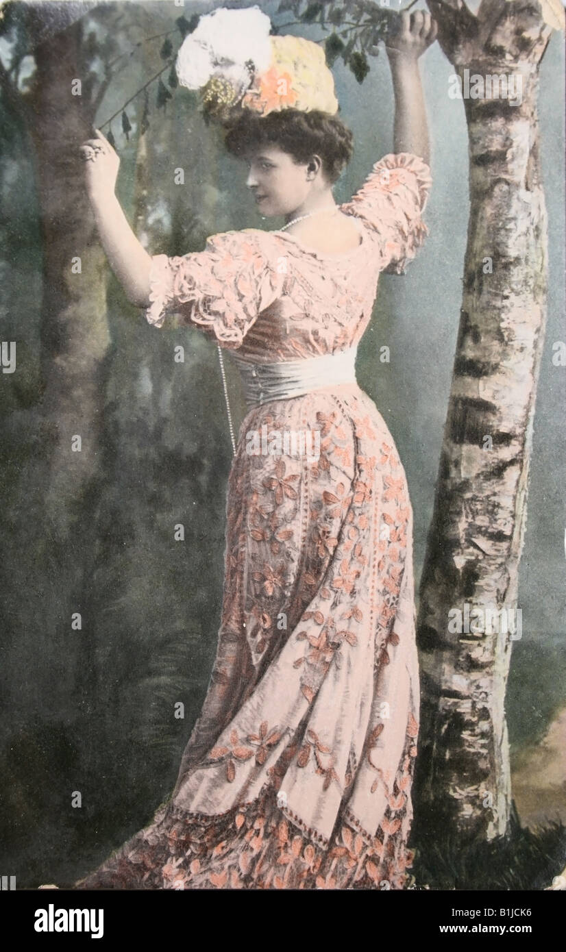 Vintage postcard with handpainted photograph of beautiful lady in fashion dress of 1910 Stock Photo