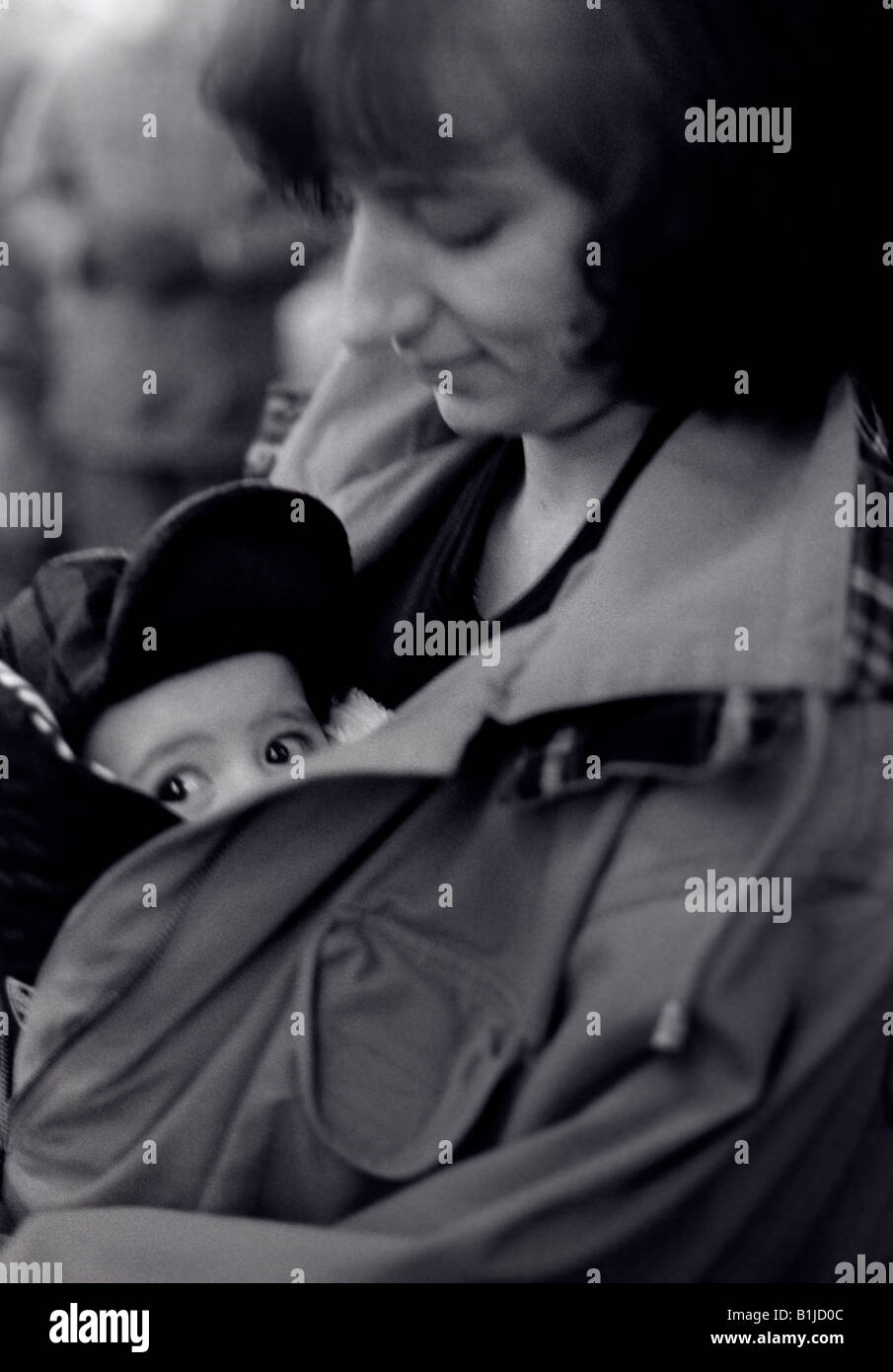 Black and white of a young woman holding a baby Stock Photo - Alamy