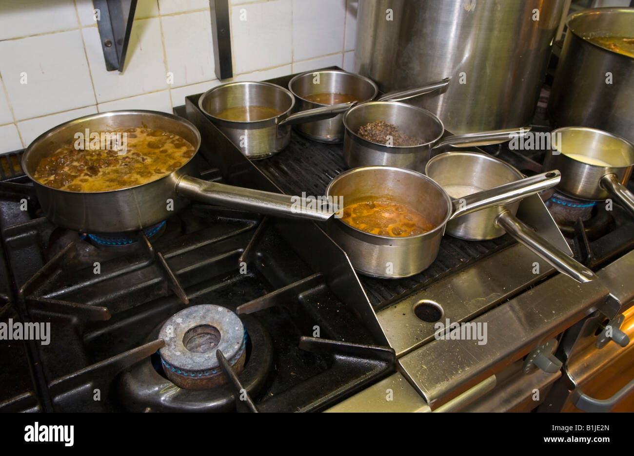Pans simmering on the stove at The Walnut Tree Restaurant Llanddewi Skirrid Abergavenny Monmouthshire Wales UK Stock Photo