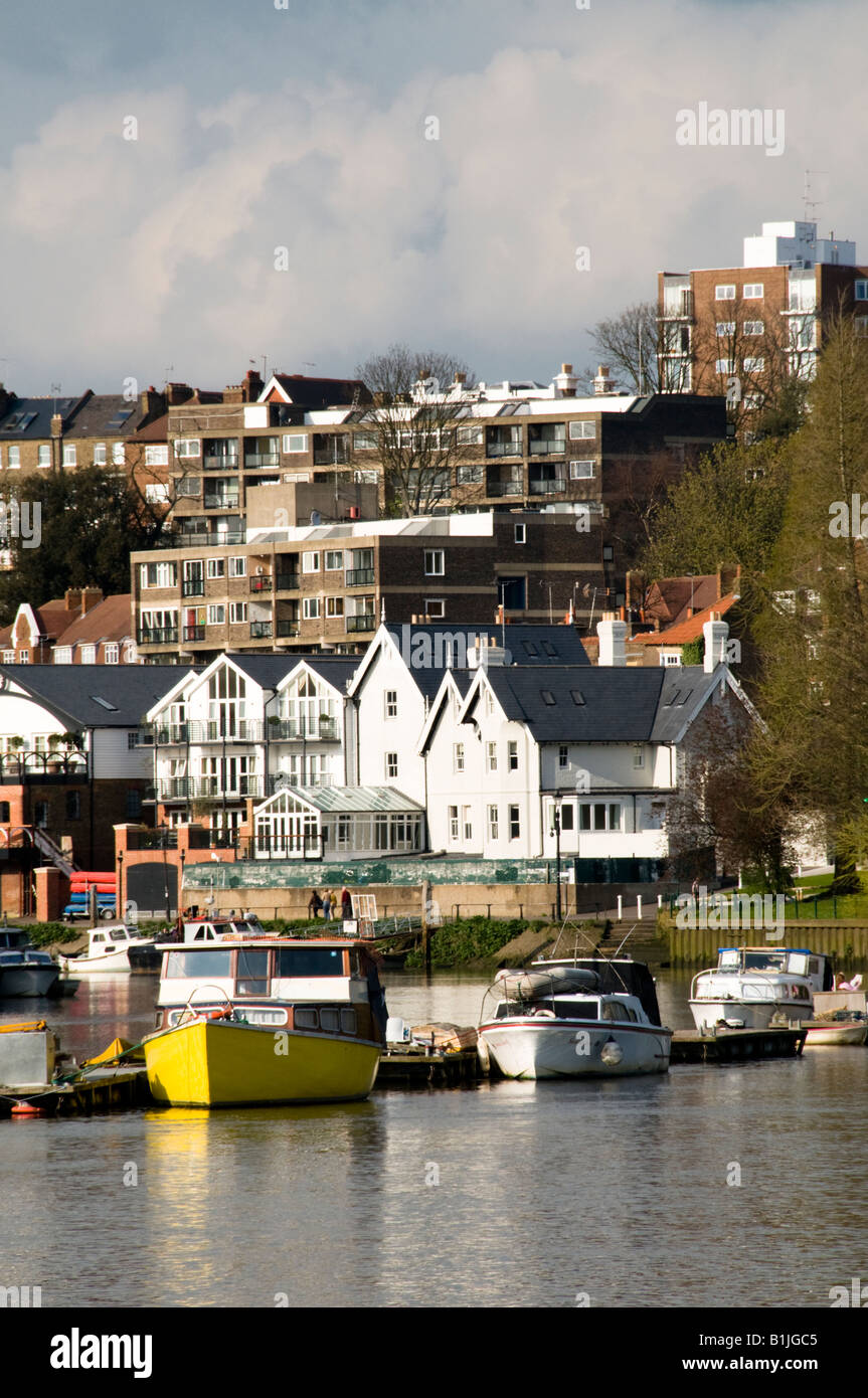 Boats on River Thames with houses and flats in the background, Richmond, Surrey, England Stock Photo