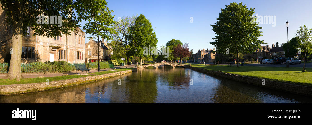 Early morning on the River Windrush flowing through the Cotswold village of Bourton on the Water, Gloucestershire Stock Photo