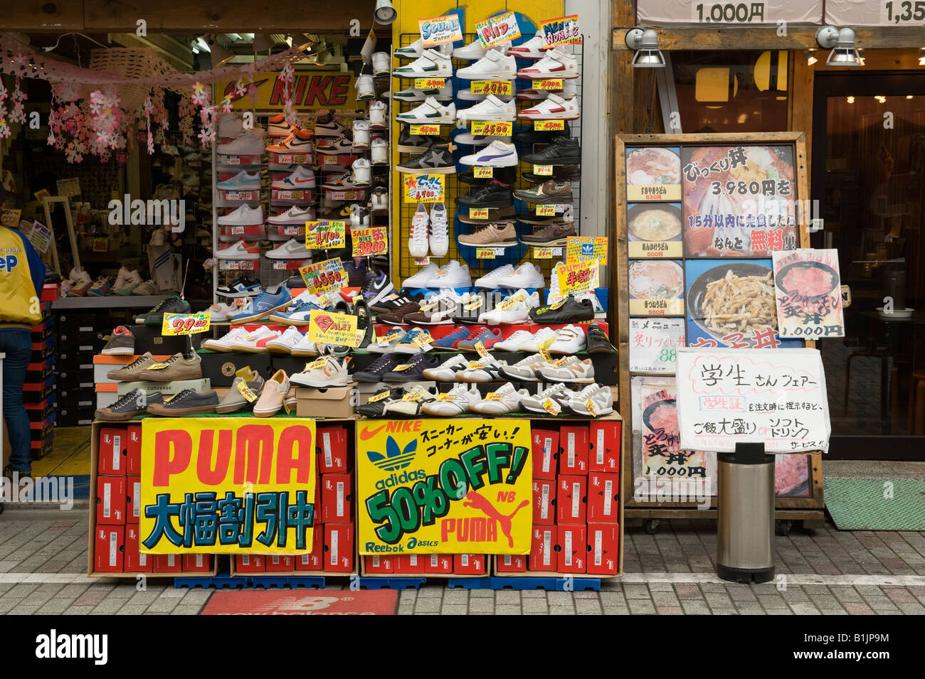 A display of trainers outside a shoe shop in central Kyoto, Japan, offering  reductions on the leading brands Stock Photo - Alamy