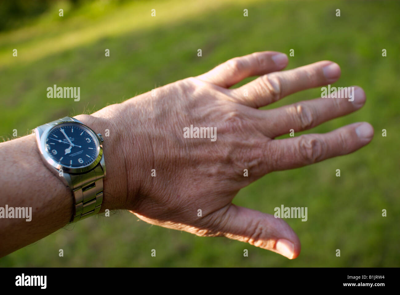 rolex in hand