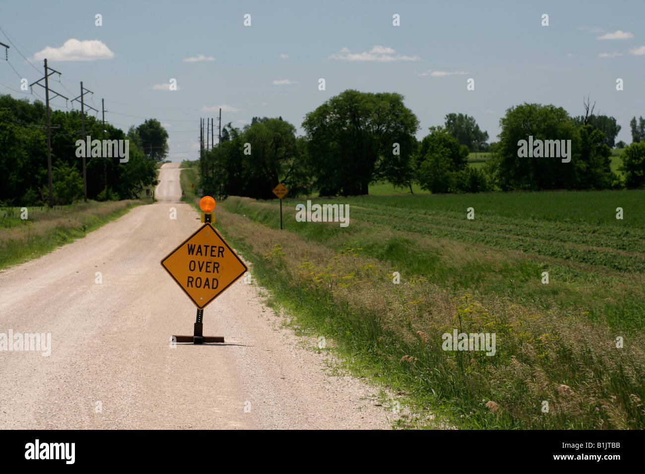 Flood warning on country road Stock Photo - Alamy