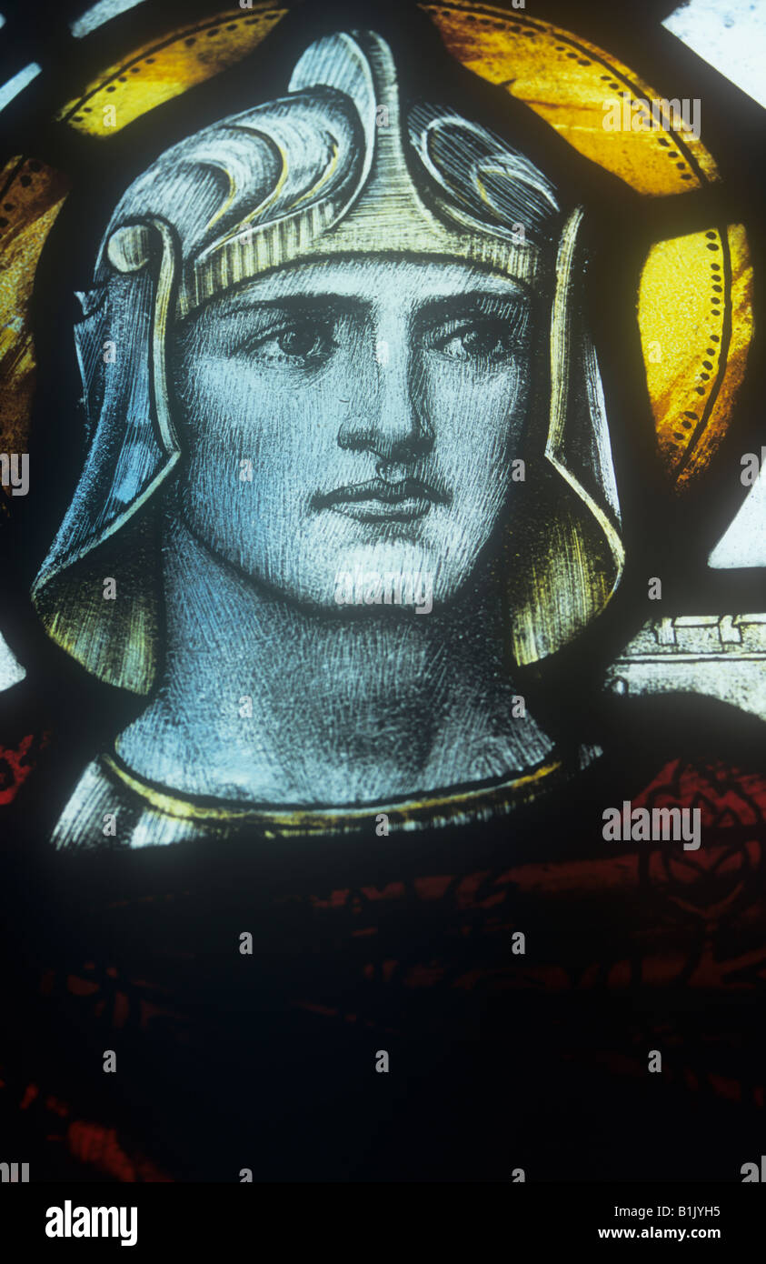 Detail of early 20th century stained glass window showing head and shoulders of St George with Roman helmet and halo Stock Photo