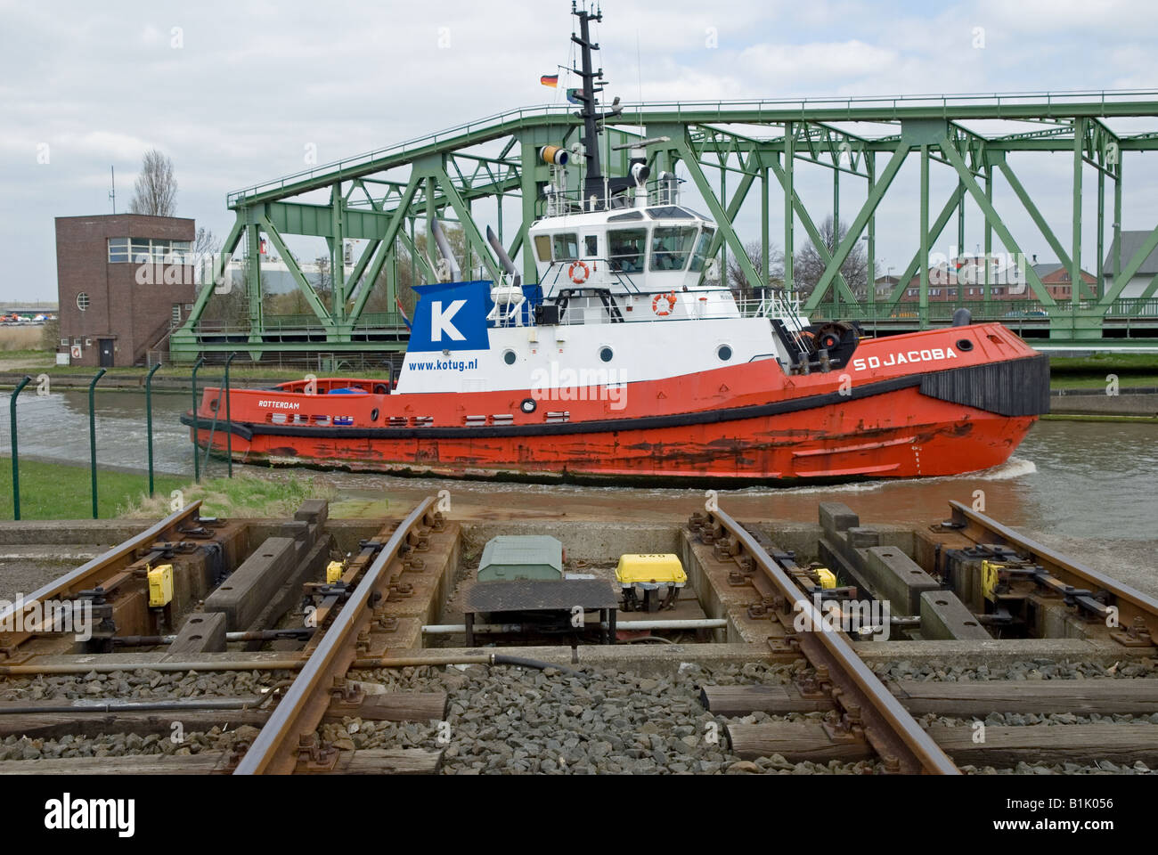 Railway swing bridge in open position to let tug pass through at the Port of Bremerhaven, Germany. Stock Photo