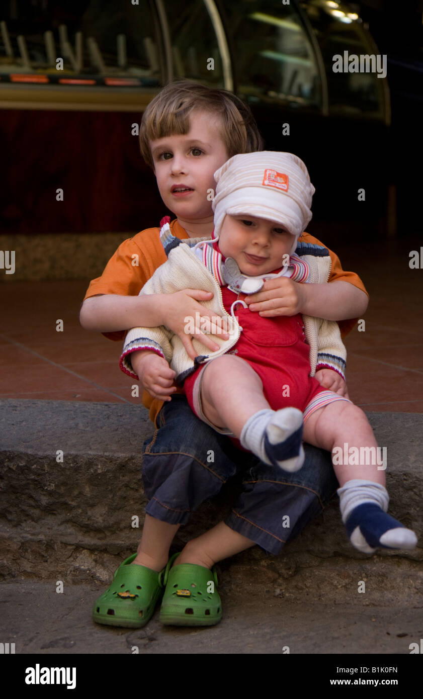 little boy holding baby Stock Photo Alamy