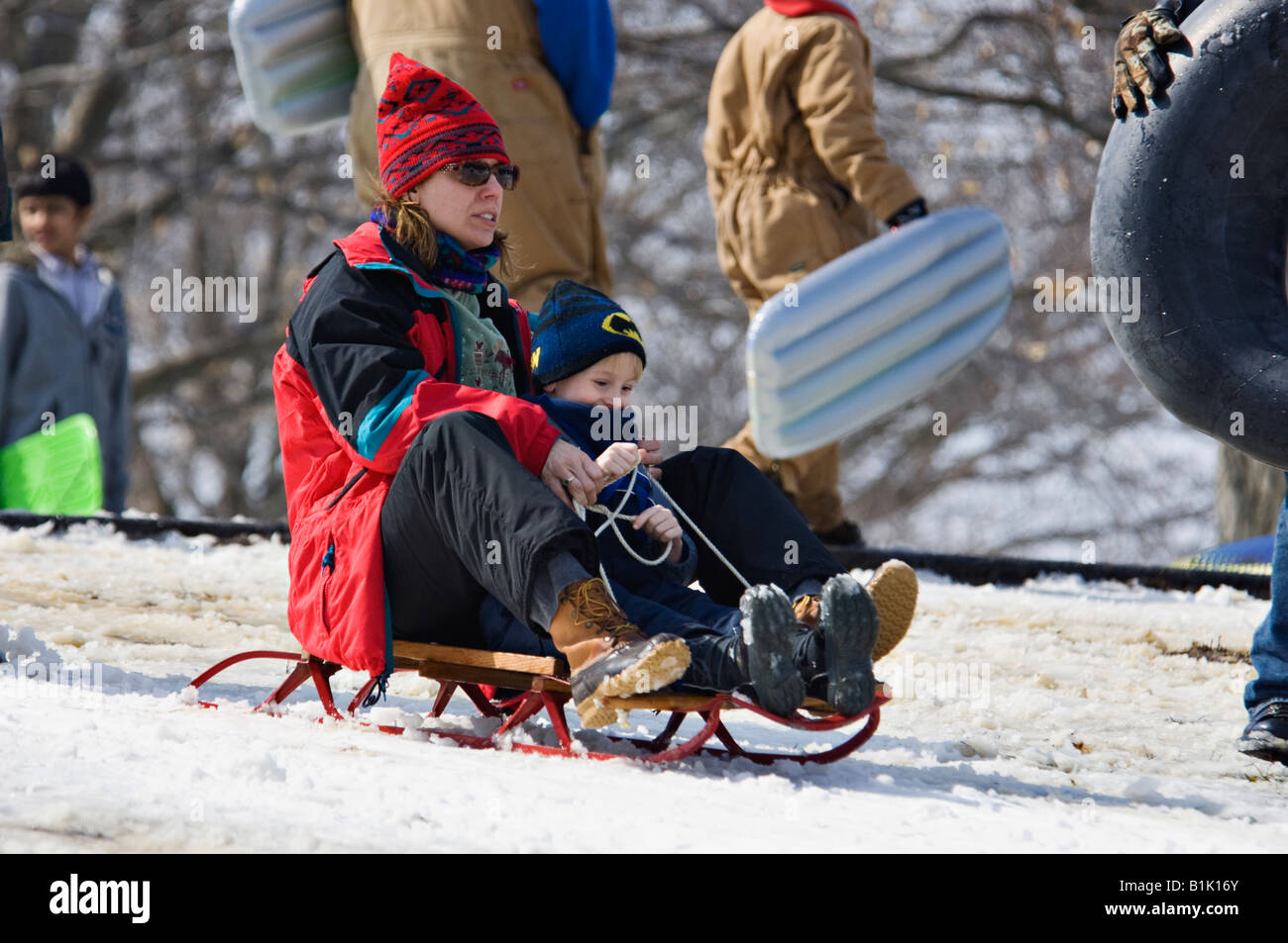Woman and Young Boy Sledding on Snow Covered Hill in Cherokee Park ...