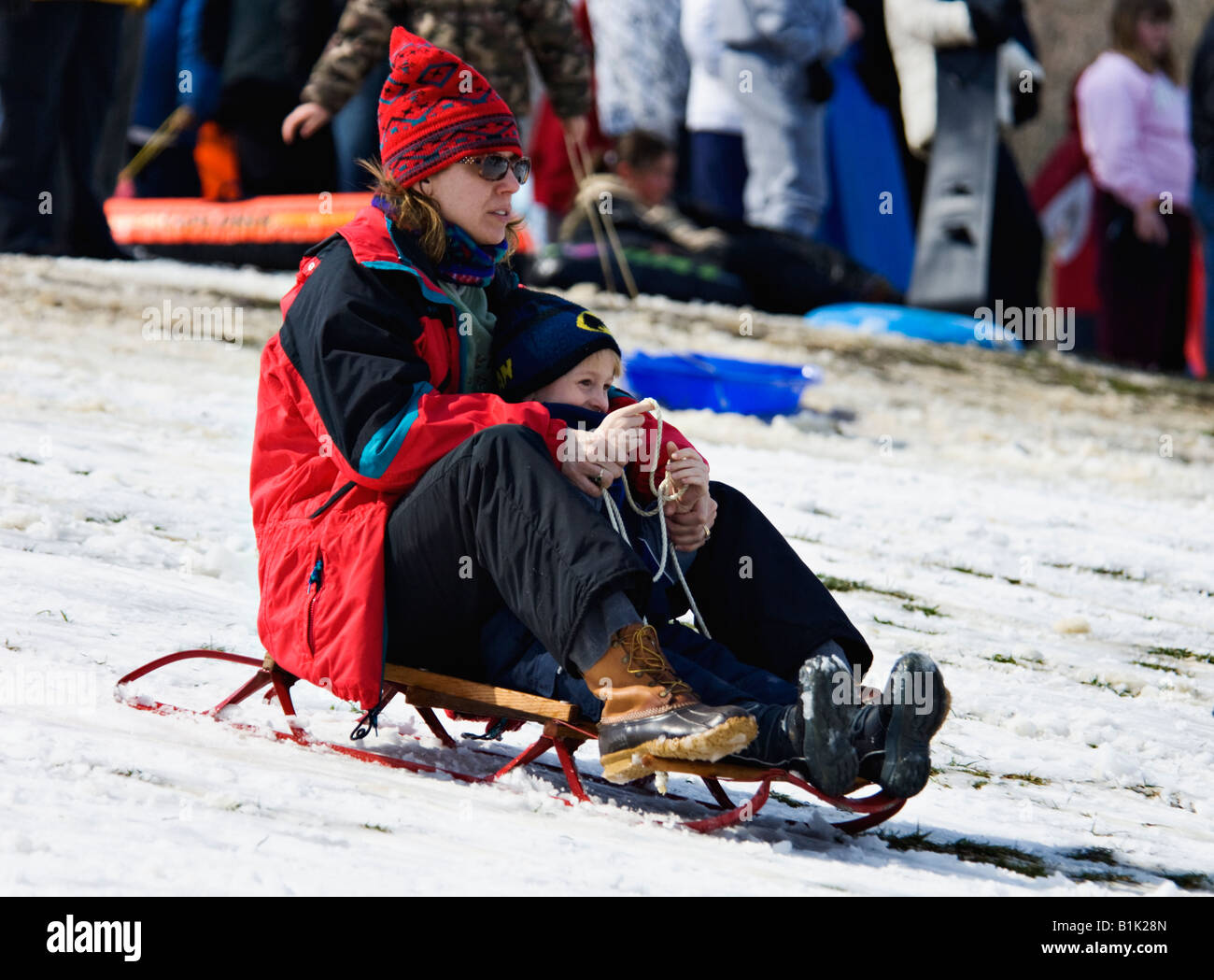 Woman and Young Boy Sledding on Snow Covered Hill in Cherokee Park ...