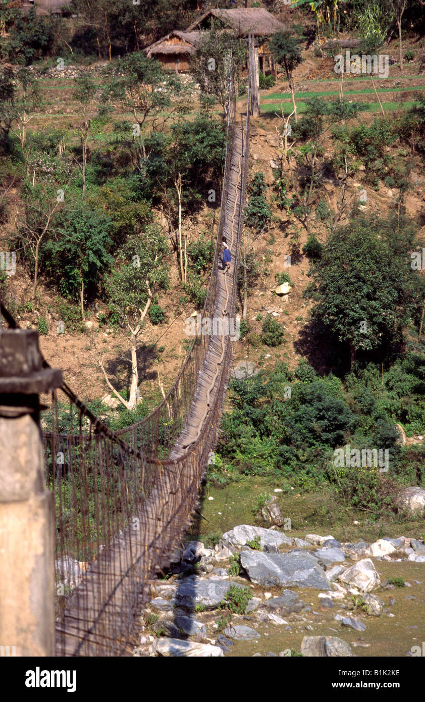 Nepal Central girl crossing Trisuli River by decrepit old rope bridge Stock  Photo - Alamy