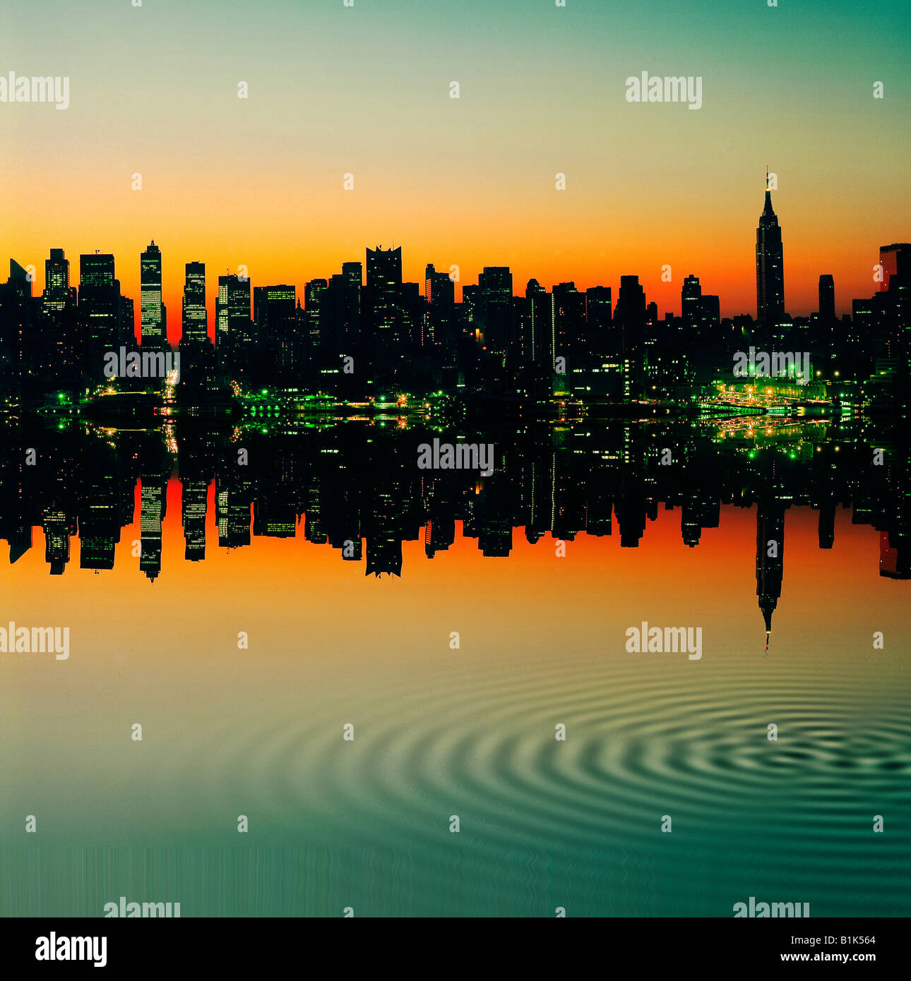 Empire State Building and New York skyline at sunset reflected in East ...
