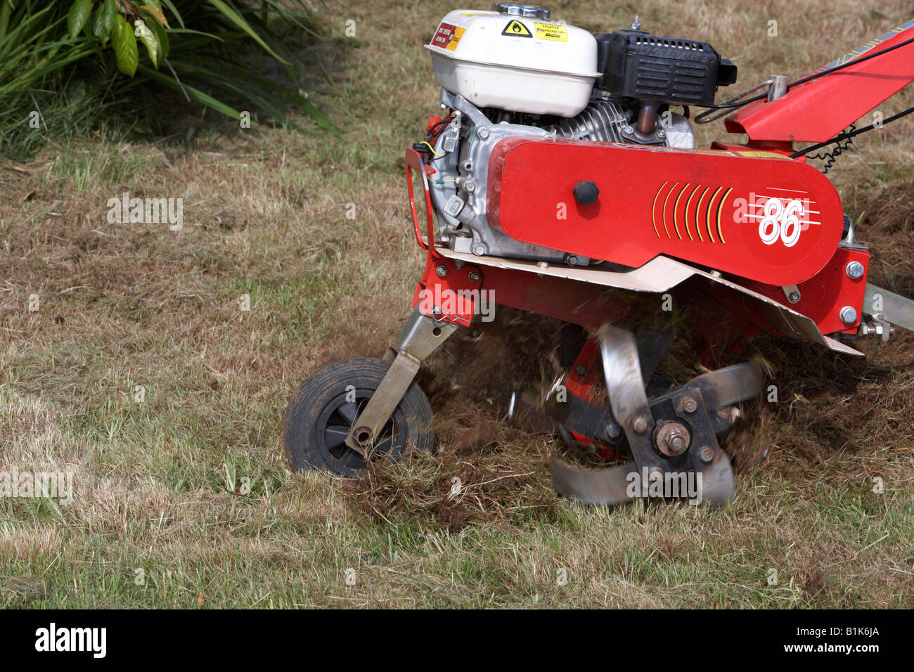 Petrol Driven Garden Rotavator Being Used To Churn Up Soil In A