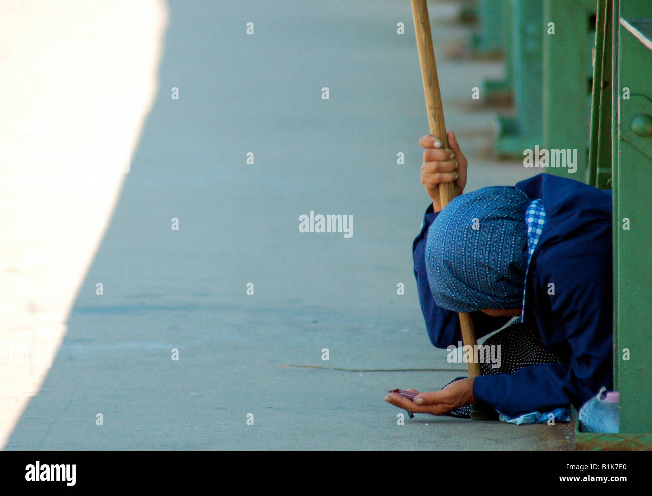 A homeless woman begs passers-by for spare change in Budapest, Hungary ...