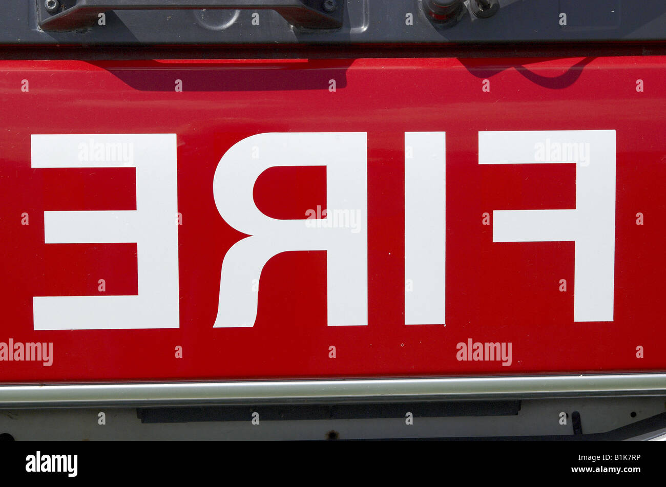 Reversed FIRE sign on the front of a British fire engine. Stock Photo