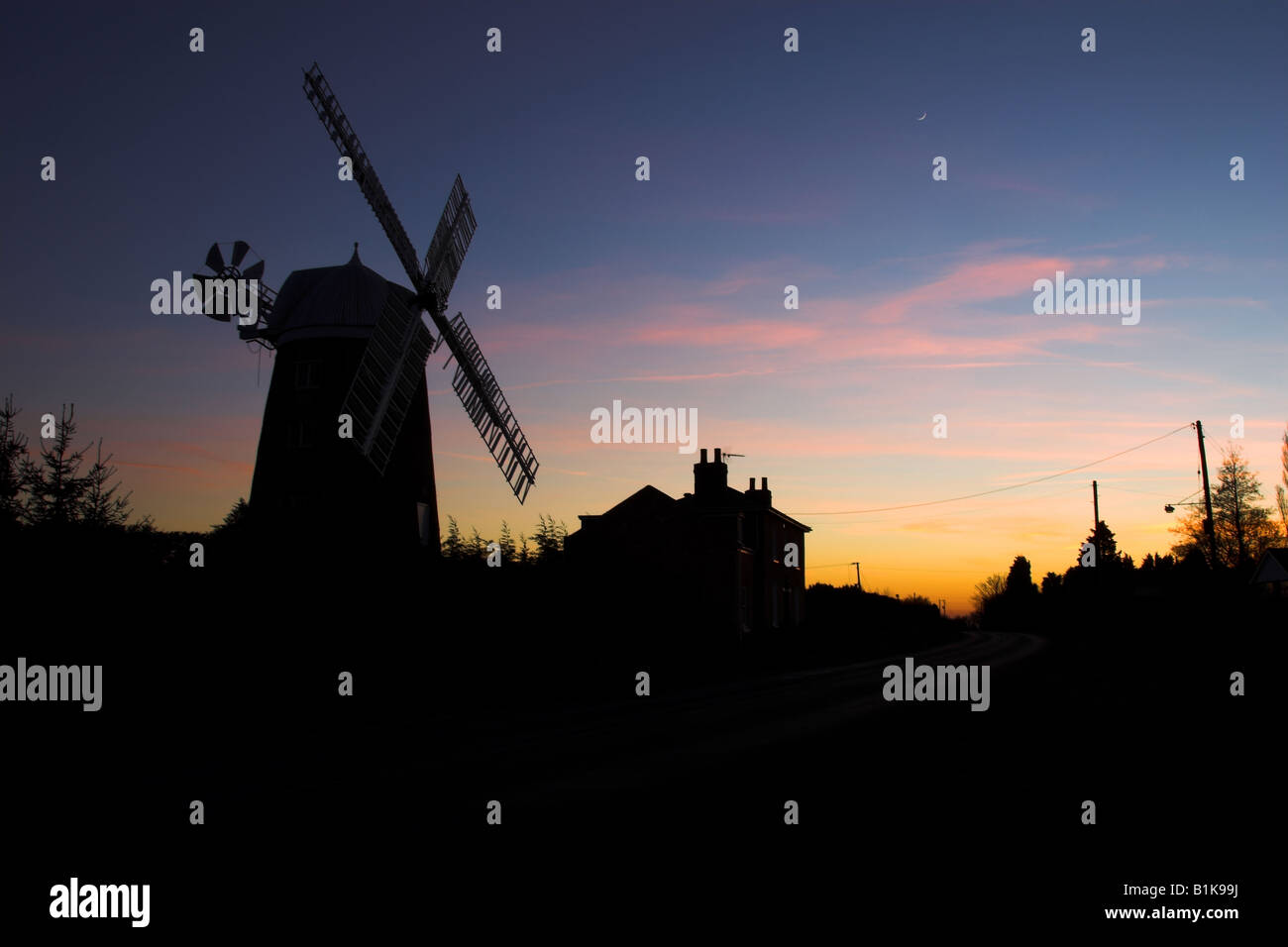 Silhouetted windmill at dusk on the road between Haddenham and Aldreth