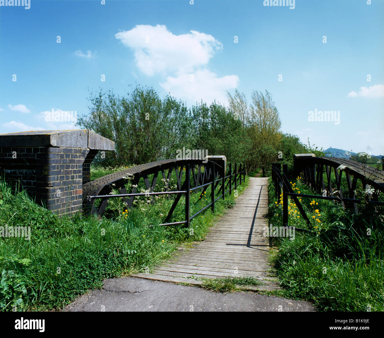 An old railway bridge over the River Brue in the Somerset Levels near Glastonbury, now used as a cycle path. Somerset, England. Stock Photo