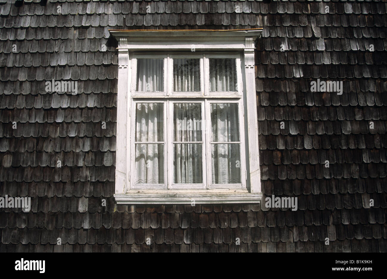 Detail of window traditional wooden house and wall shingles, Puerto Varas, Región de Los Lagos, Chile Stock Photo