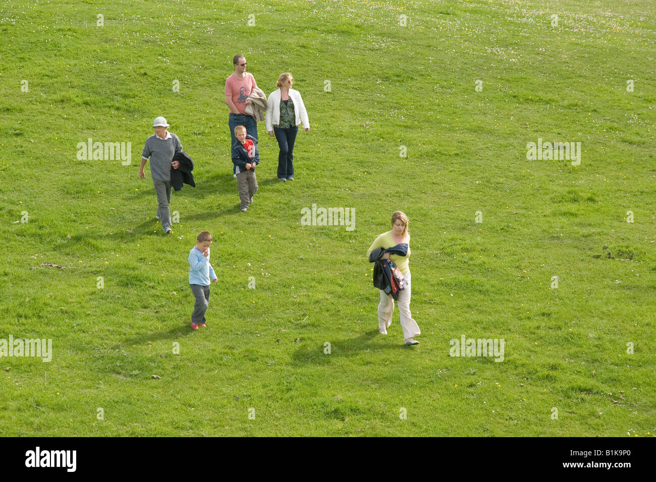 Family walking on a meadow, from above perspective, England, UK Stock Photo