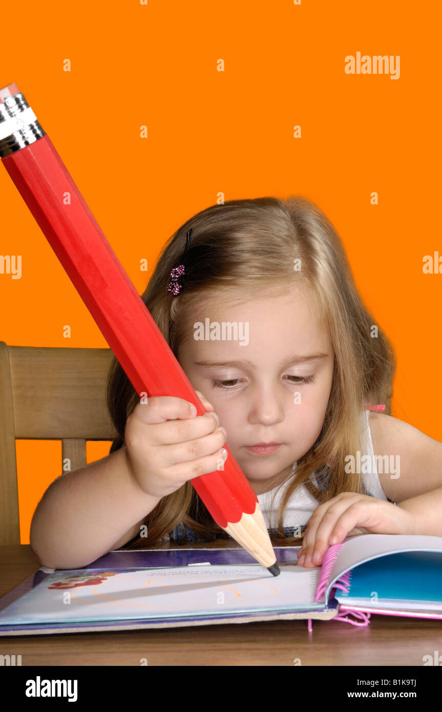 Young girl with a big pencil Stock Photo