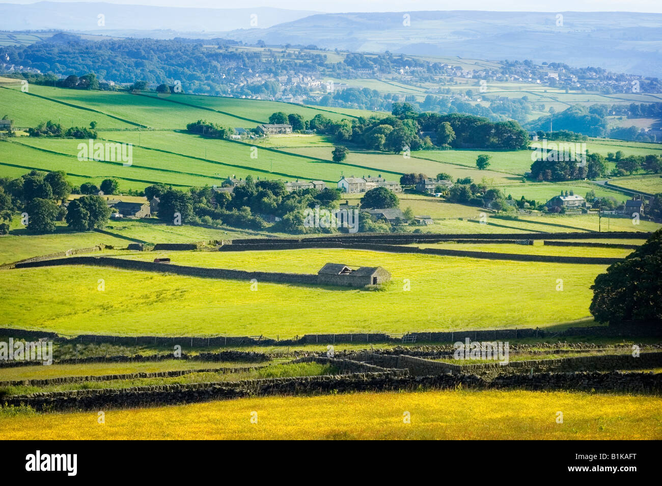 A disused farm building, with the village of Oxenhope; West Yorkshire in the background. Stock Photo