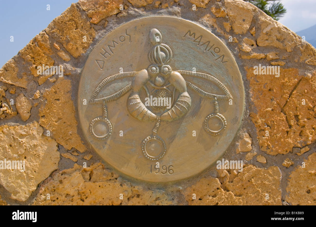 Ancient bee symbol outside traditional church at Malia on the Greek Mediterranean island of Crete Stock Photo