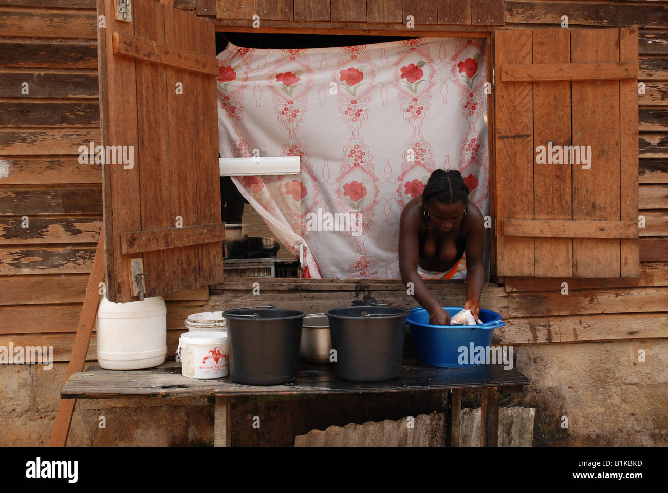 black woman cleaning a piranha fish Apatou Haut Maroni French Guyana South America Stock Photo