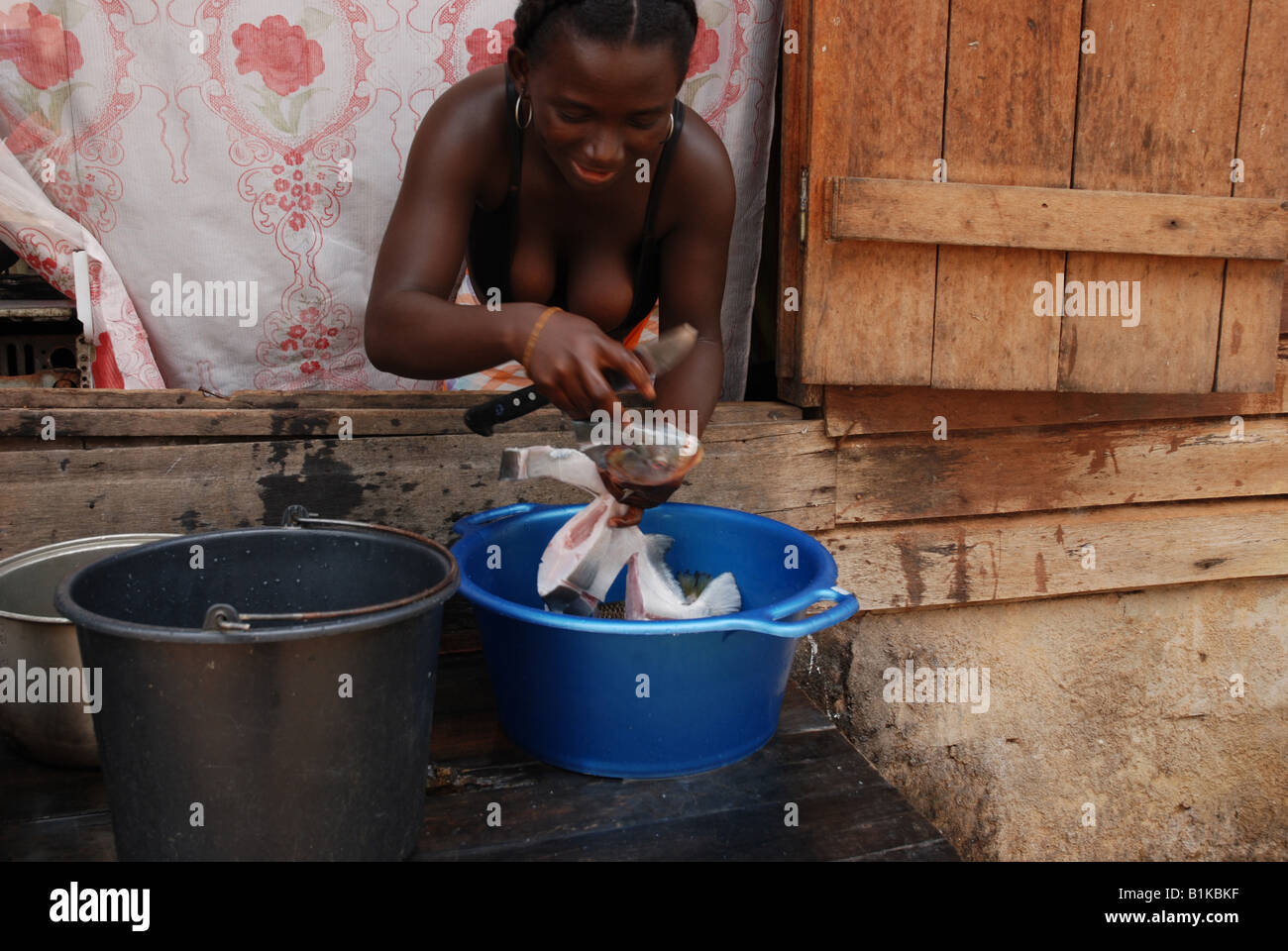 black woman cleaning a piranha fish Apatou Haut Maroni French Guyana South America Stock Photo