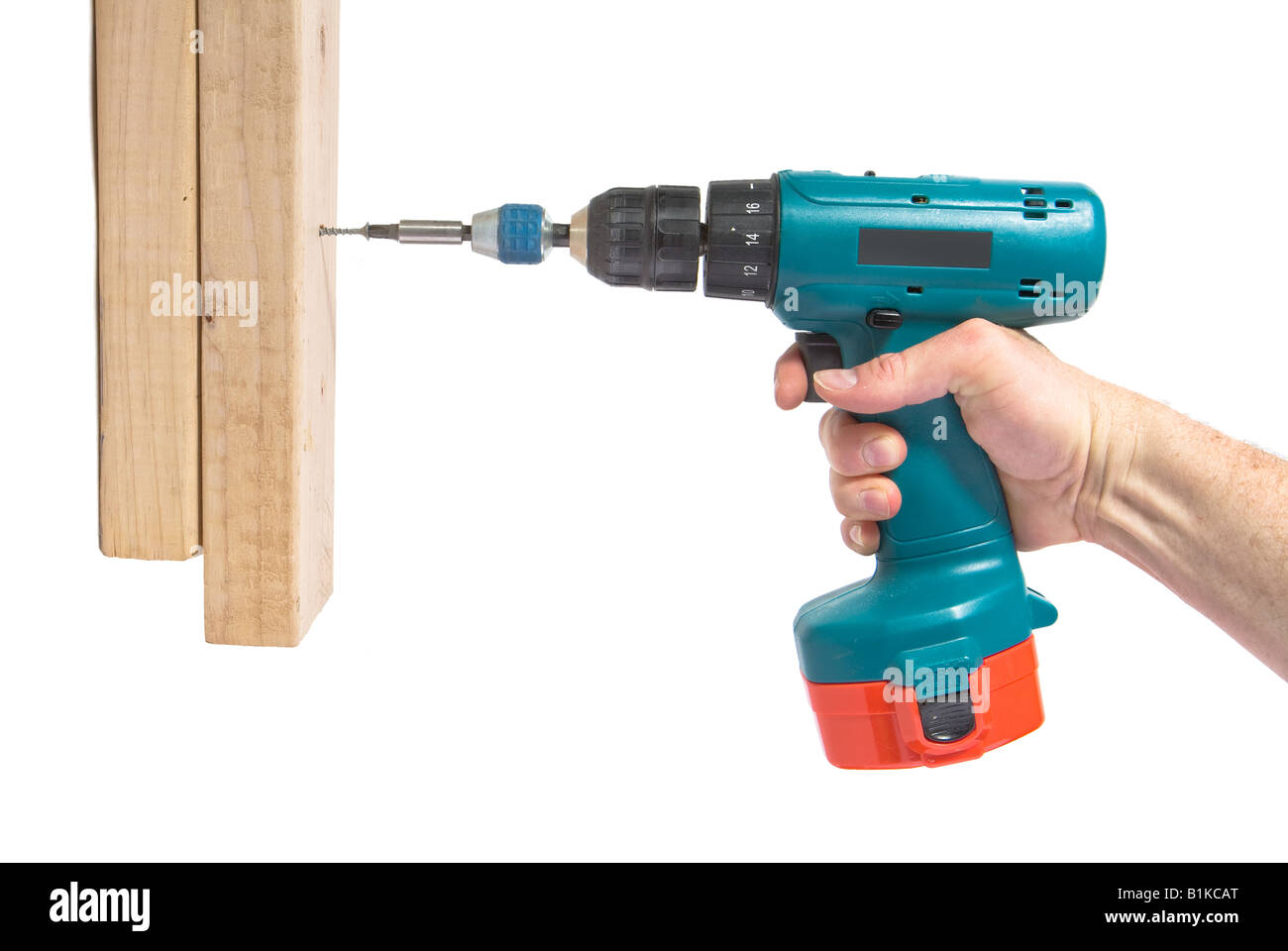 Handyman using cordless drill to drive a wood screw into 2x4s Stock