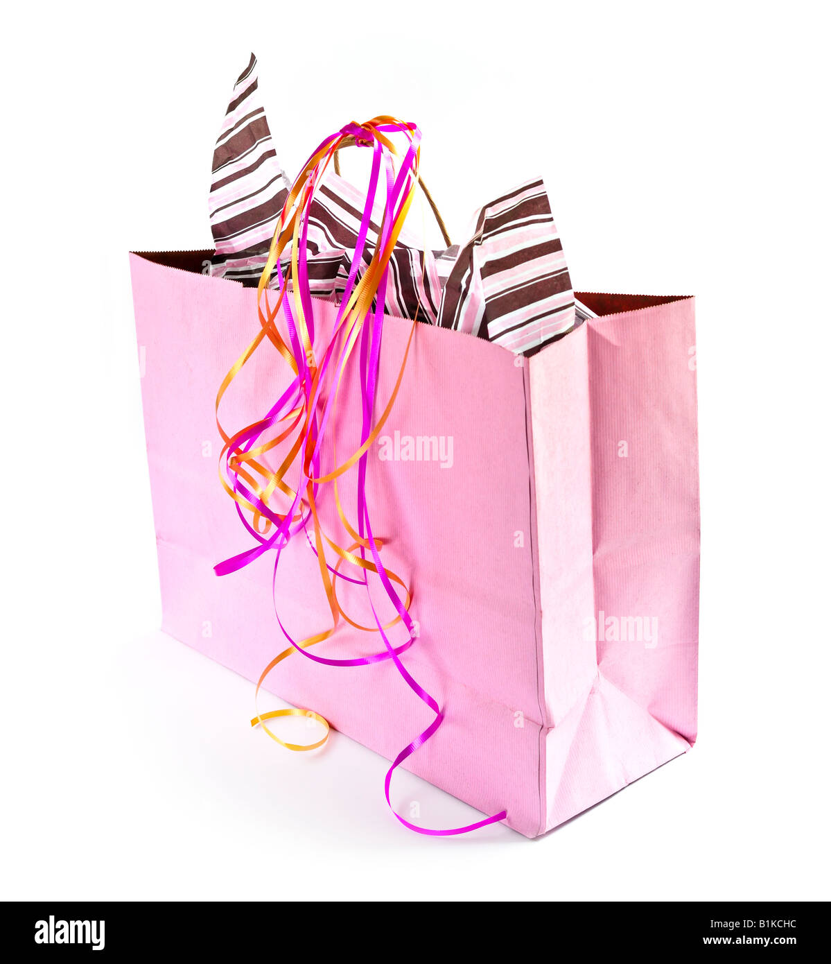 Pink shopping bag with ribbons isolated on white background Stock Photo