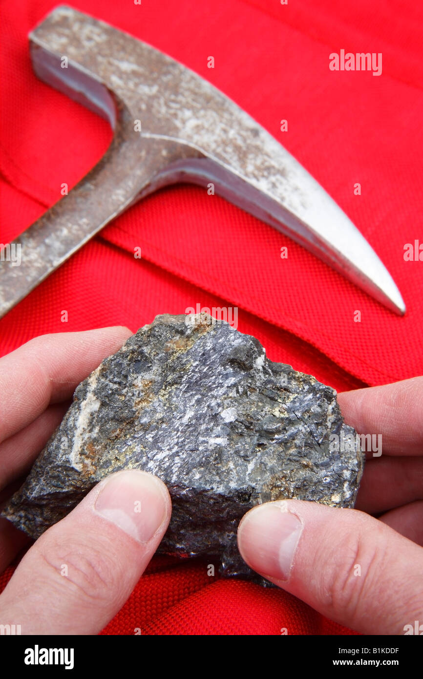 Mining  concept of ore sample and geologists rock hammer Stock Photo