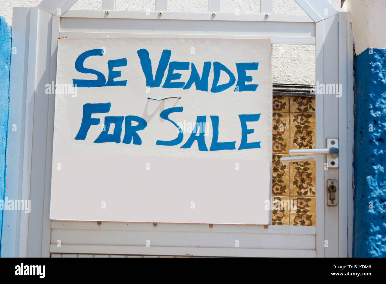 For sale sign in Spanish and English on gate of house on Gran Canaria