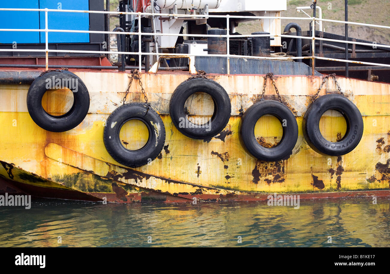 Old car tyres form a line of fenders on a rusting ship Stock Photo Alamy