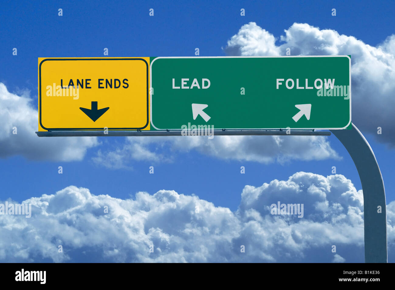 Freeway sign in blue cloudy skies reading Lead and Follow Stock Photo