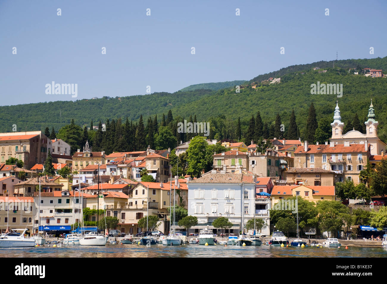 Volosko Istria Croatia Moored boats in picturesque old fishing village on Opatija Riviera on Kvarner Gulf coast from offshore Stock Photo