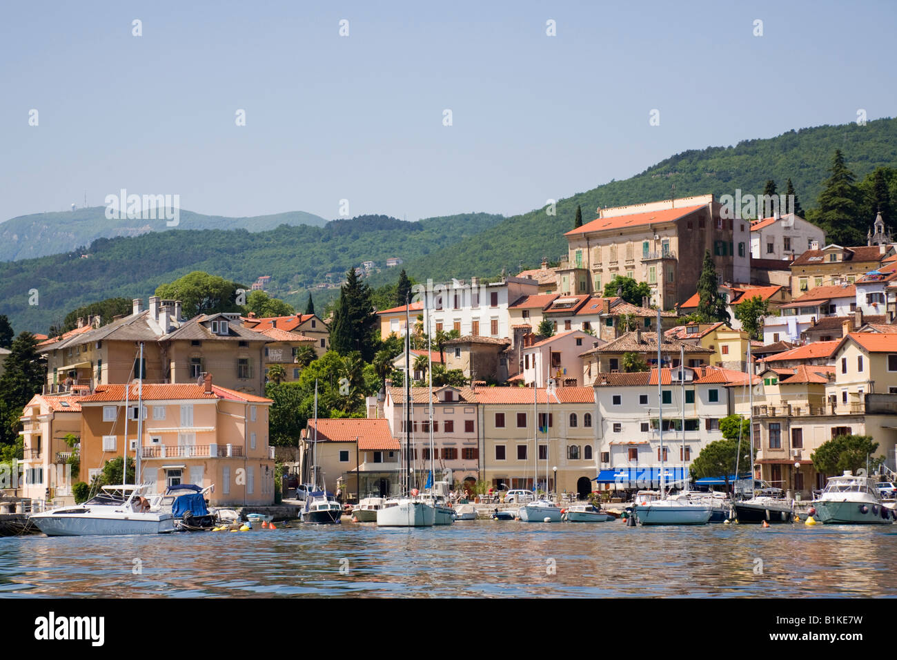 Volosko Istria Croatia Moored boats in picturesque old fishing village on Opatija Riviera on Kvarner Gulf coast from offshore Stock Photo