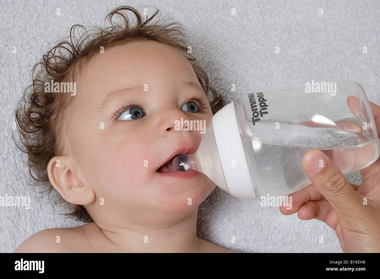 little baby being bottlefed water Stock Photo