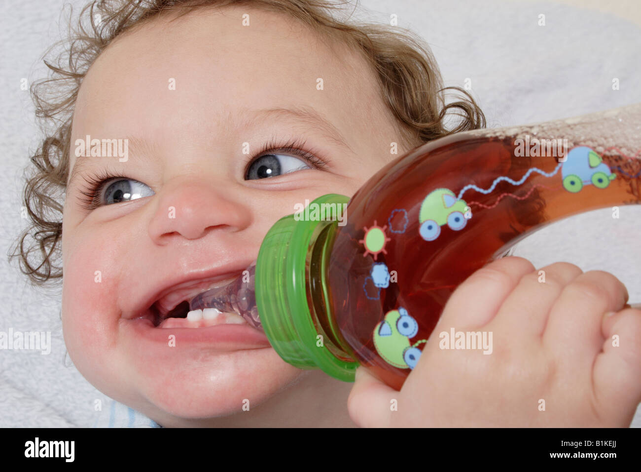 little baby drinking fruit juice from bottle Stock Photo Alamy