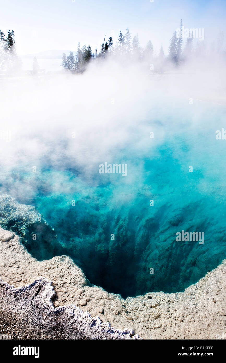 Image looking down into the the turqoise blue waters of Blue Funnel Spring in the West Thumb basin of Yellowstone National Park Stock Photo