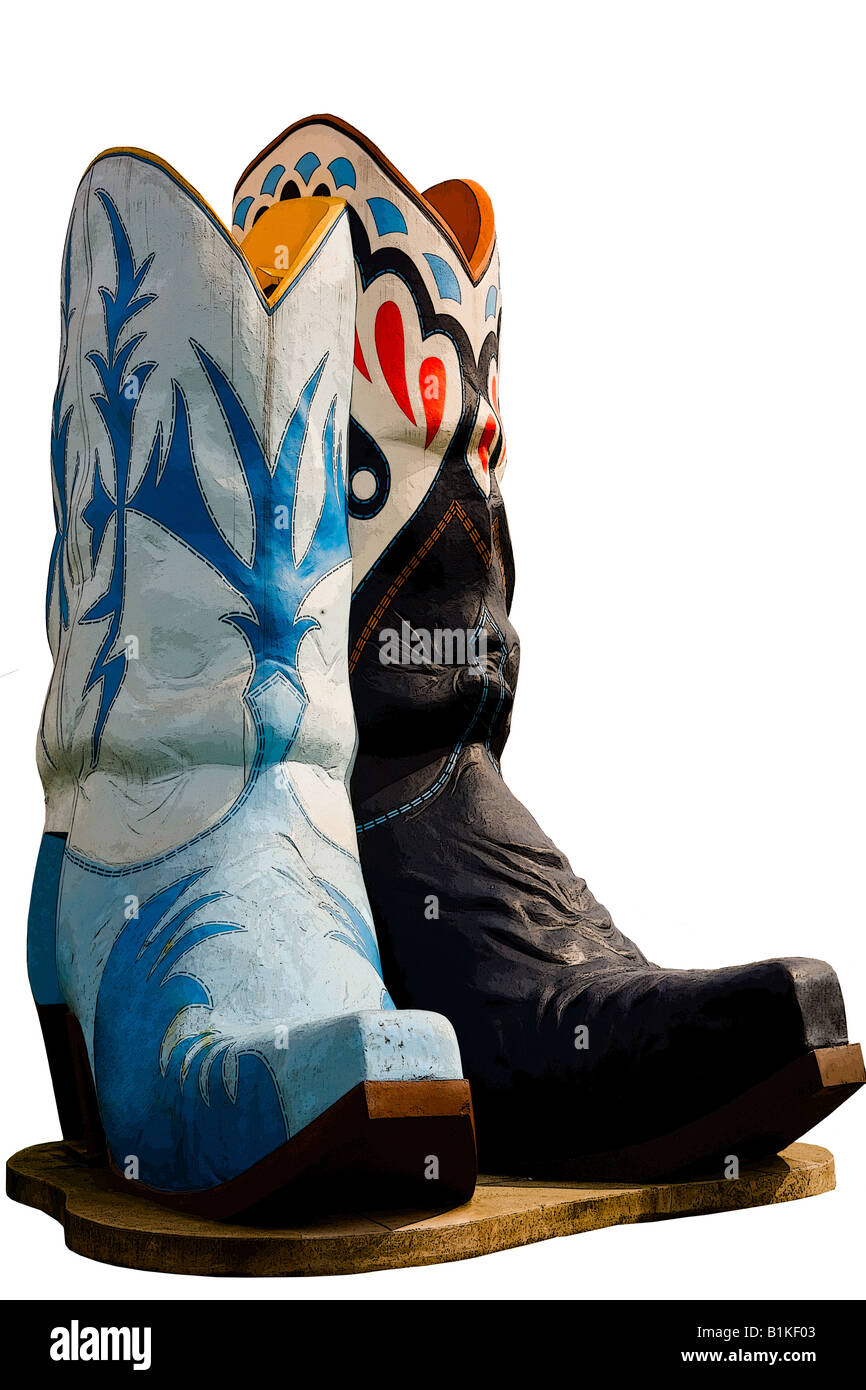 Pair of colorful mismatched cowboy boots on a pedistal set against a white background Stock Photo