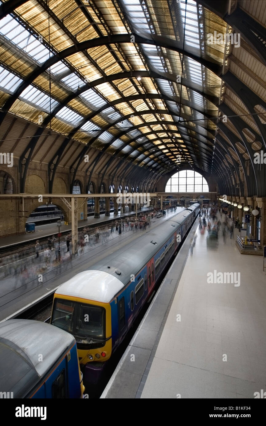 A passenger train stands by the platform at Kings Cross in London while