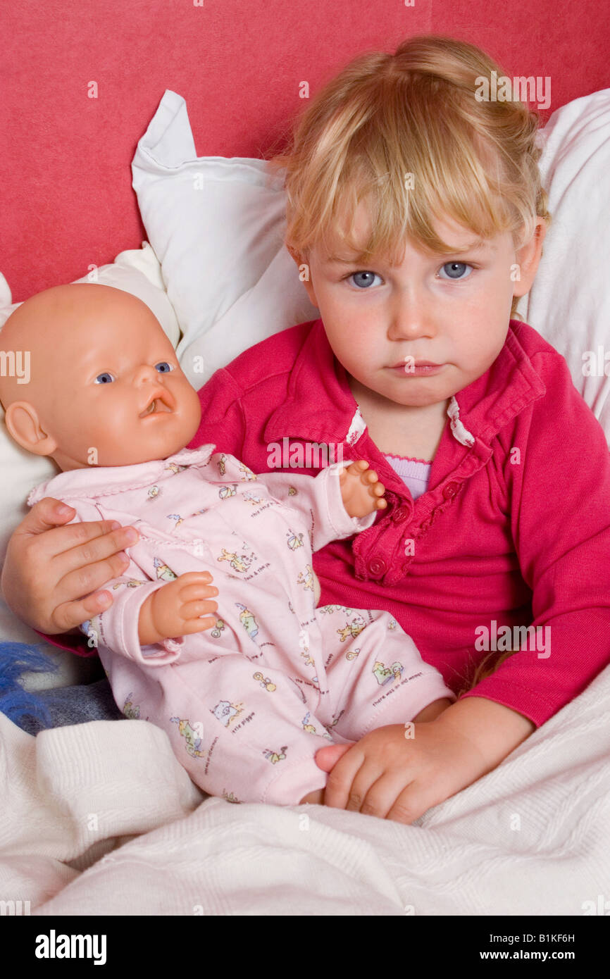 little girl playing with her doll Stock Photo - Alamy