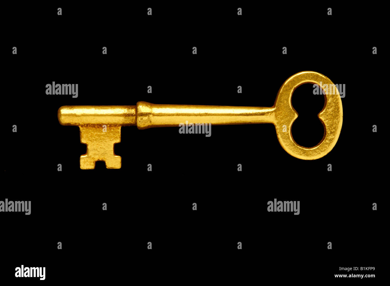 Gold or brass key against black background Stock Photo - Alamy