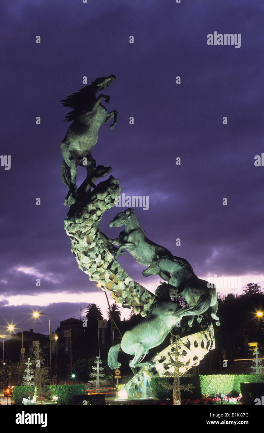 Los Caballos /  The Horses metal horse sculpture by Juan José Oliveira in Plaza España at twilight, Vigo, Galicia, Spain Stock Photo