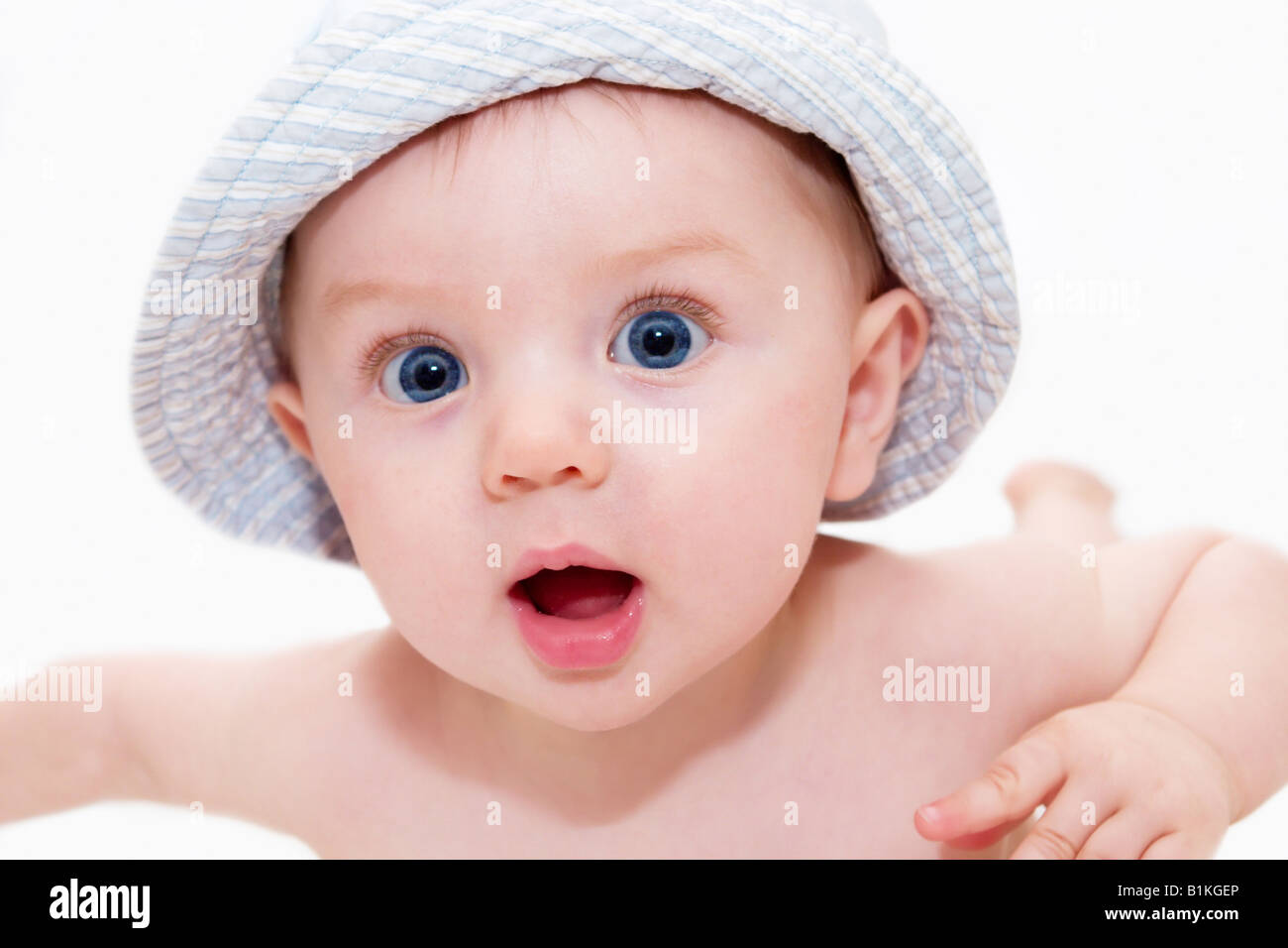 Blue eyed baby boy wearing a hat and looking at camera Stock Photo - Alamy