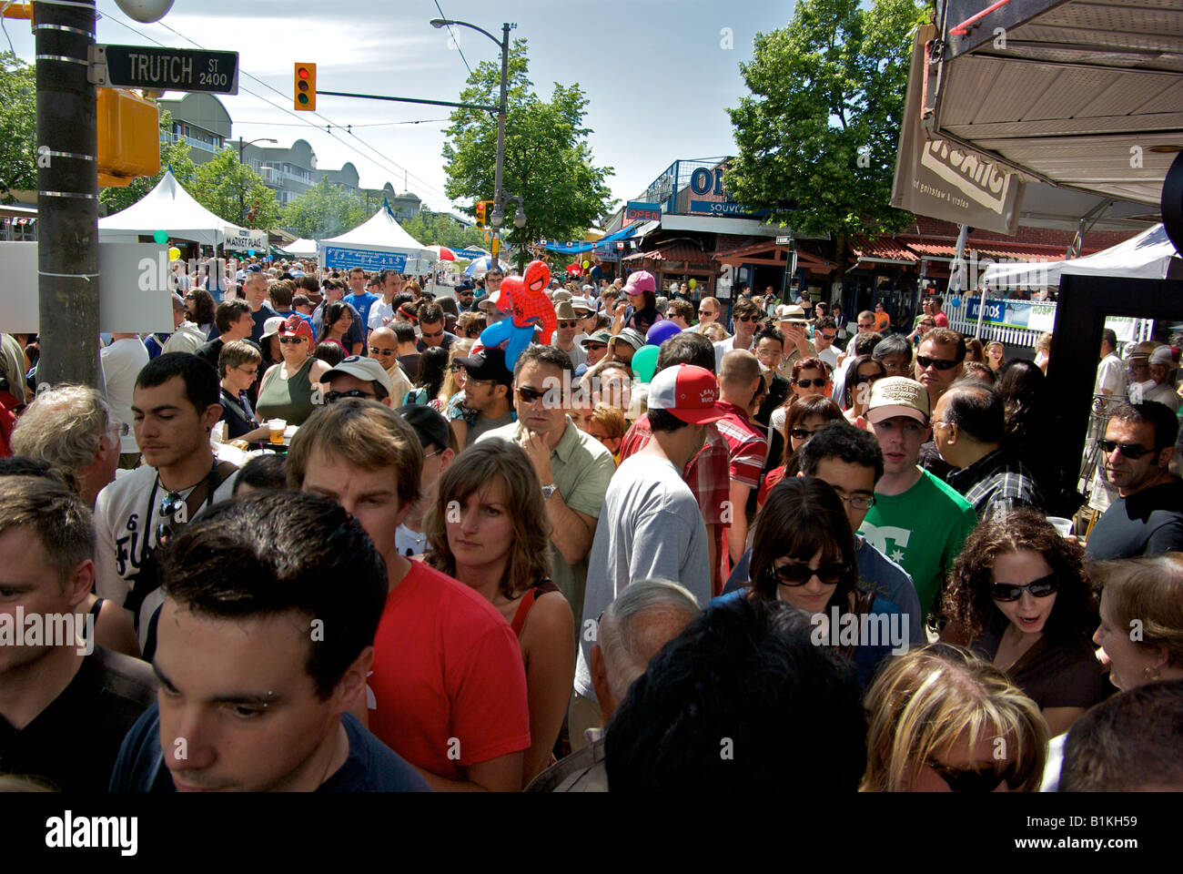 Massive throng of people crowd the city sidewalk and street at the Massive throng of people crowd the city sidewalk and street at the