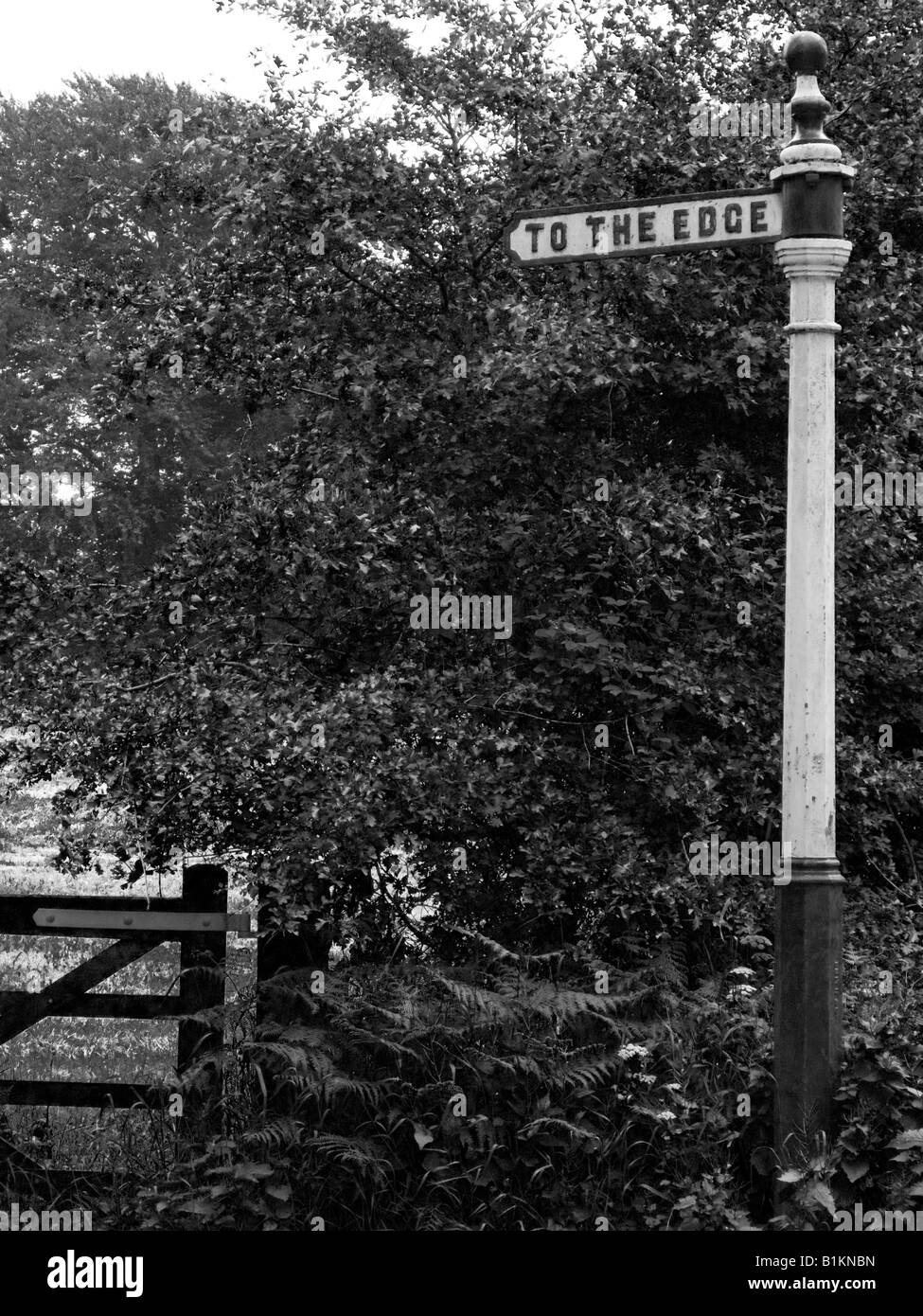 Old iron sign post saying TO THE EDGE. At Alderley Edge, in Cheshire, near Manchester. Black and white photograph. Monochrome. Stock Photo