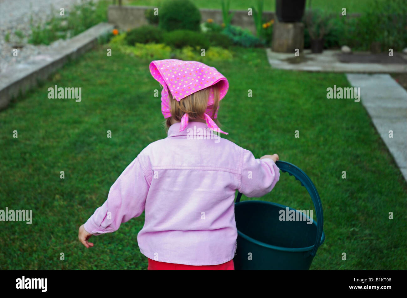Child walking with bucket hires stock photography and images Alamy